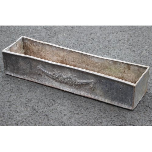 884 - A lead trough planter, of rectangular form, moulded in relief with foliate swags to the side panels,... 