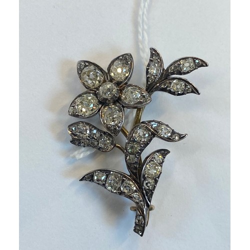 136 - A late 19th century diamond set spray brooch, designed as a flower with old cut diamonds set through... 