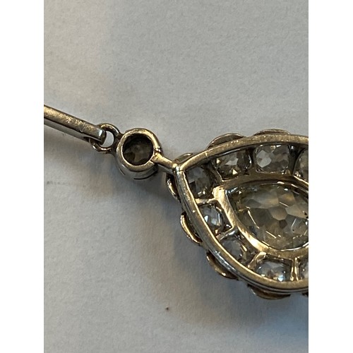 198 - An early 20th century pear cut diamond pendant, the central pear cut diamond within surround of ten ... 