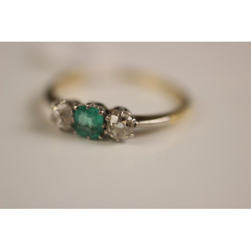 161 - An early 20th century emerald and diamond three stone ring, the central square cut emerald with an o... 