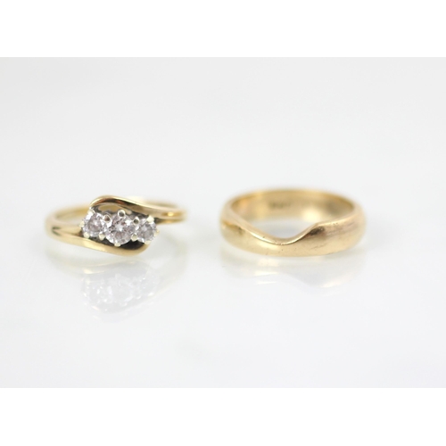 171 - A 9ct yellow gold bespoke diamond ring, the central round cut diamond with smaller diamond to each s... 