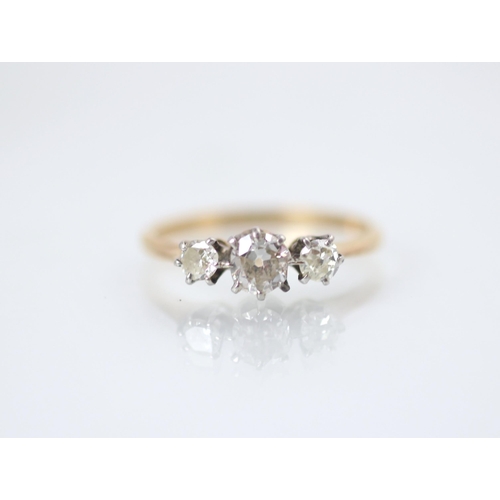 177 - A 20th century diamond three stone ring, the central round cut diamond with smaller round cut diamon... 