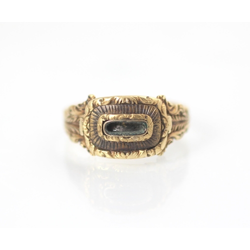 178 - A 19th century style yellow metal mourning ring, the central vacant locket within carved mount and c... 