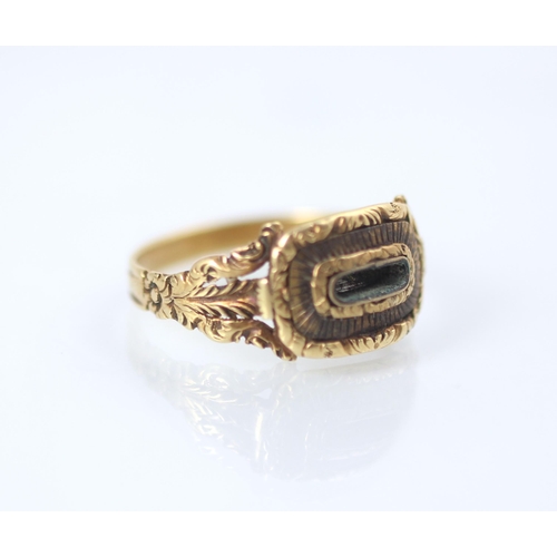 178 - A 19th century style yellow metal mourning ring, the central vacant locket within carved mount and c... 