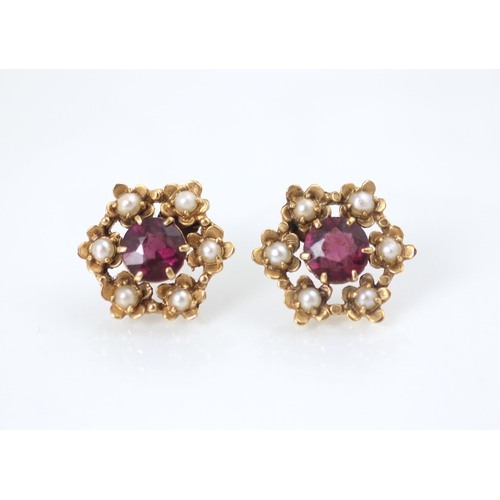 179 - A pair of Edwardian style seed pearl and red stone earrings, the round cut red stones within surroun... 