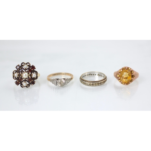 181 - A group of four rings, including a yellow metal citrine set signet style ring, stamped 9ct, ring siz... 