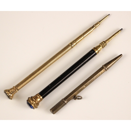 247 - A gold-plated propelling pencil, with carved terminal set with bloodstone, 12cm long, with a further... 