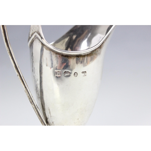 4 - A Victorian silver cream jug, Thomas Hayes, Birmingham 1892, the reeded loop handle above helmet sha... 