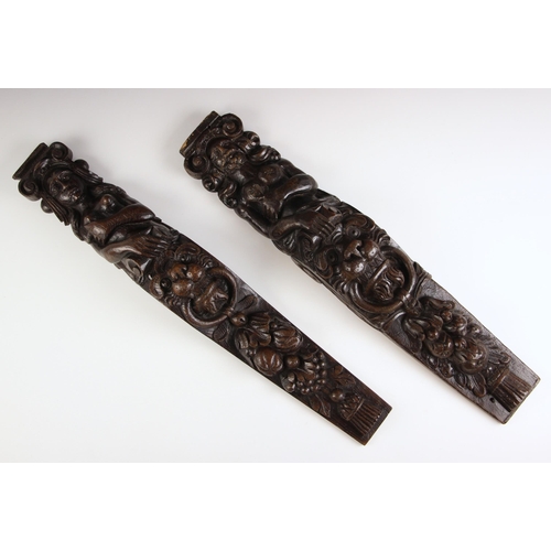 657 - A pair of 17th century style carved oak figural terms, each carved with a figure over a lions mask a... 