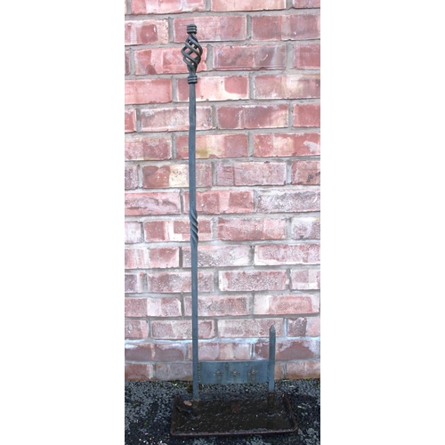 662 - A wrought iron boot scraper, with an open twist finial upon an iron twist support, 111cm high