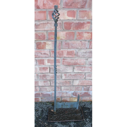 662 - A wrought iron boot scraper, with an open twist finial upon an iron twist support, 111cm high