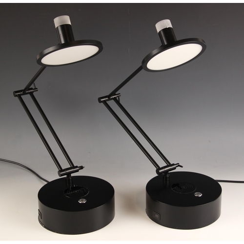 681 - A pair of Heals of London table lamps, each with adjustable arm, upon circular base, in a black matt... 