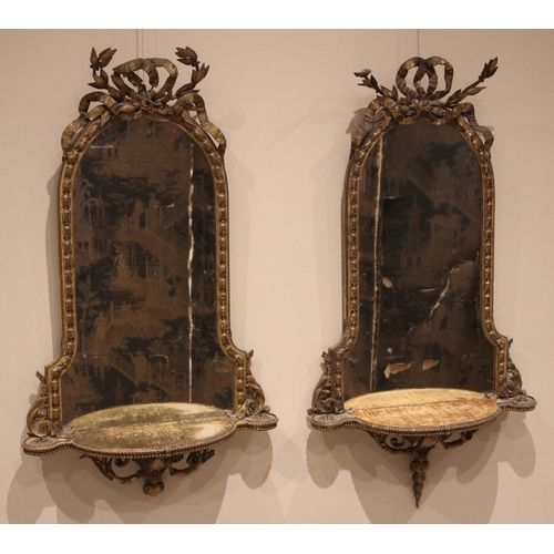 706 - A pair of mid-19th century giltwood and gesso mirrored wall shelves, each with an acanthus and ribbo... 