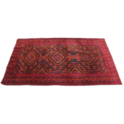 725 - A fine woven rich red and blue ground Afghan Beluchi tribal rug, the three central radiating lozenge... 