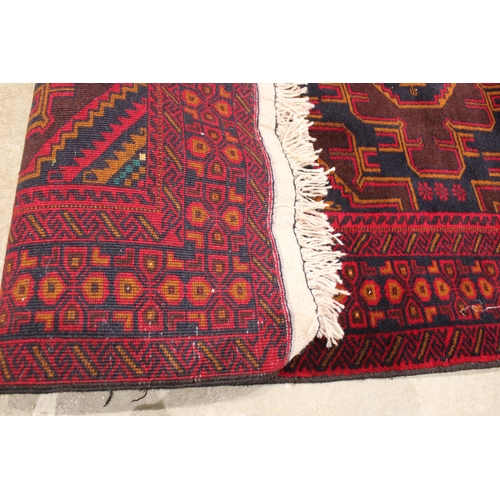 725 - A fine woven rich red and blue ground Afghan Beluchi tribal rug, the three central radiating lozenge... 