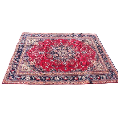 727 - A large multi coloured field vintage Persian Mashad carpet with traditional floral medallion upon a ... 