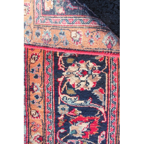 727 - A large multi coloured field vintage Persian Mashad carpet with traditional floral medallion upon a ... 