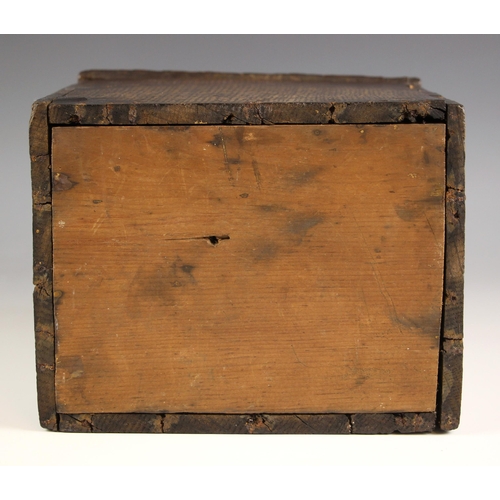 747 - An 18th century oak candle box, the shaped back over a sloping hinged cover, later pine base, 36cm H... 