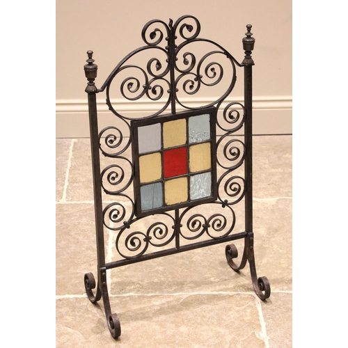 753 - An Arts & Crafts style firescreen, early 20th century, the central leaded coloured glass panel set t... 