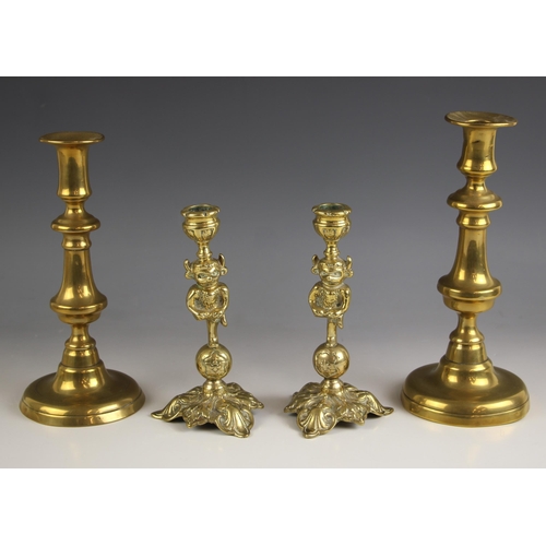 754 - A pair of late 19th century ‘Grotesque’ brass candlesticks, each upon shaped base, 17cm high, with a... 