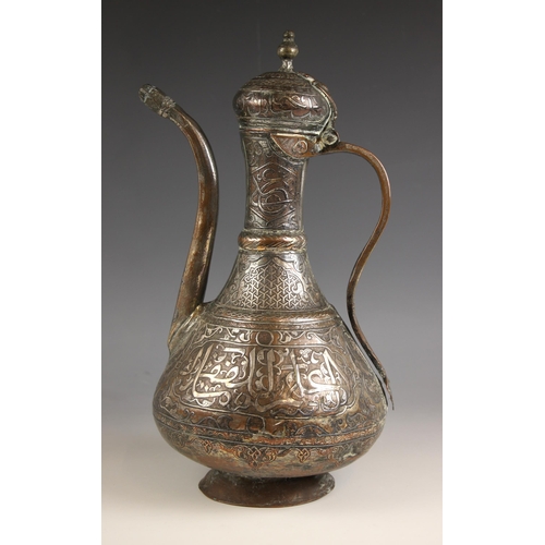 756 - A 19th century copper ewer and cover, possibly Islamic, with typical geometric and character decorat... 