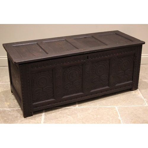 773 - A late 17th/early 18th century oak coffer, the four panel hinged cover above a nulled frieze and fou... 