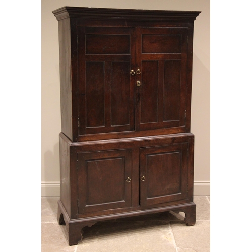 775 - An 18th century oak livery/hall cupboard, of cottage proportions, probably Welsh, the moulded cornic... 