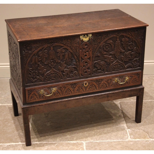 778 - An 18th century and later carved oak mule chest, the profusely carved chest with a hinged cover abov... 