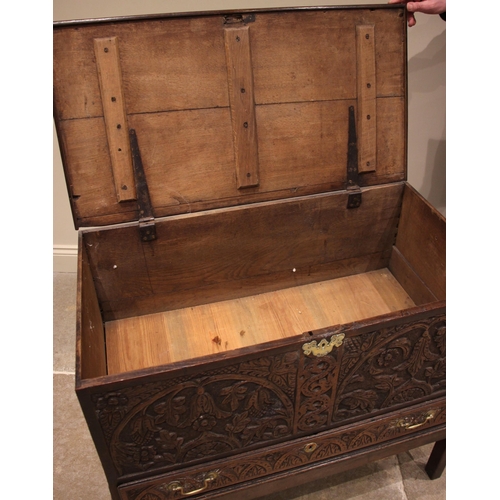 778 - An 18th century and later carved oak mule chest, the profusely carved chest with a hinged cover abov... 