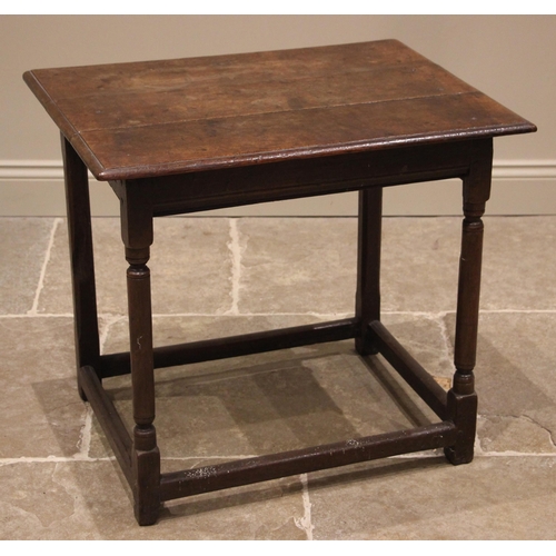 779 - An 18th century oak side table, the moulded three plank top over a frieze drawer to the side, upon t... 