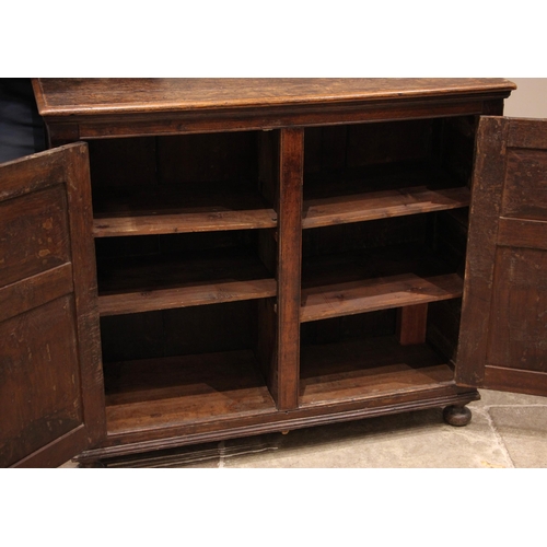 780 - An 18th century and later oak spice cupboard, the rectangular moulded top over canted corners flanki... 