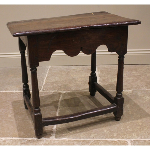 791 - A 17th century Welsh oak side table, the moulded plank top upon tapering cylindrical and block suppo... 