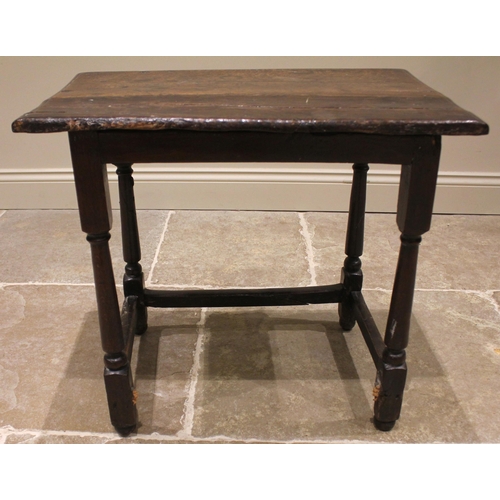 791 - A 17th century Welsh oak side table, the moulded plank top upon tapering cylindrical and block suppo... 