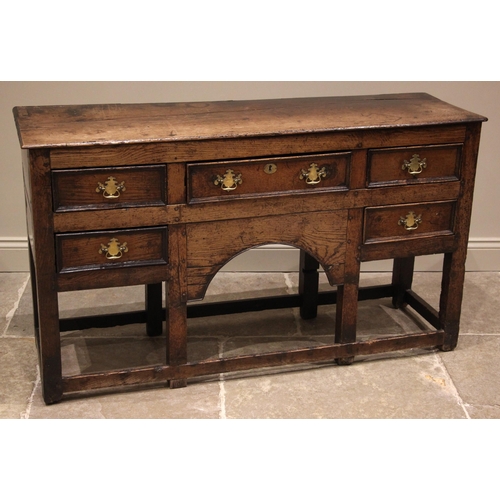 792 - An 18th century oak dresser, the open plate rack with a moulded cornice and plain frieze over three ... 