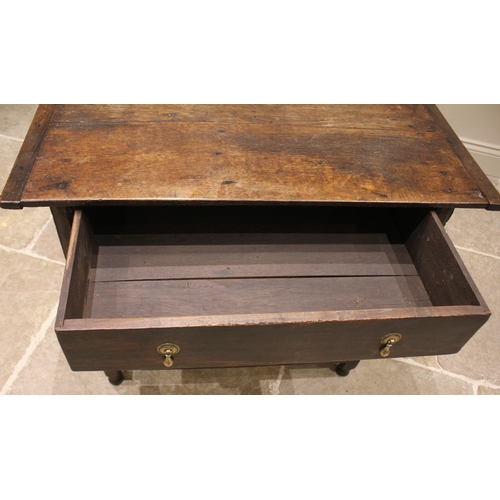 793 - An 18th century oak side table, the cleated plank top over a single oak lined frieze drawer, upon bo... 