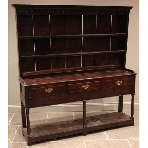 800 - An 18th century oak dresser, the rack with a moulded cornice over a plain frieze applied with iron g... 