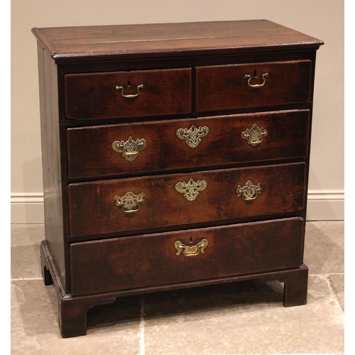 802 - A George III oak chest of drawers, formed with an arrangement of two short and three graduated long ... 