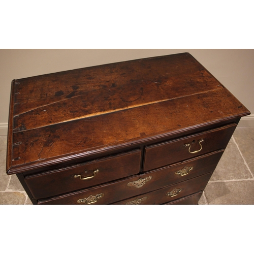 802 - A George III oak chest of drawers, formed with an arrangement of two short and three graduated long ... 