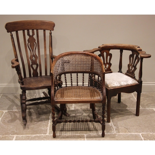 804 - An 18th century elm corner chair, the crescent shaped top rail upon twin pierced splats punctuated b... 