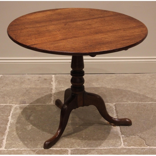 809 - A George III oak tripod table, the circular tilt top upon a turned and tapering column extending to ... 