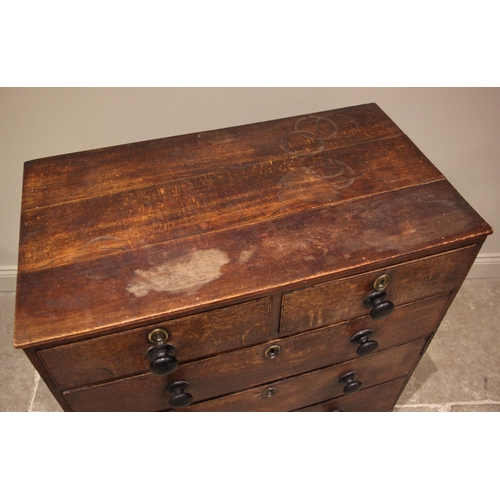 813 - A George III oak chest of drawers, formed with an arrangement of two short and three graduated long ... 