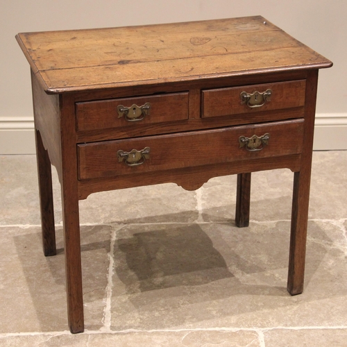 819 - A George III honey oak low boy, the three plank moulded top above an arrangement of two short and on... 