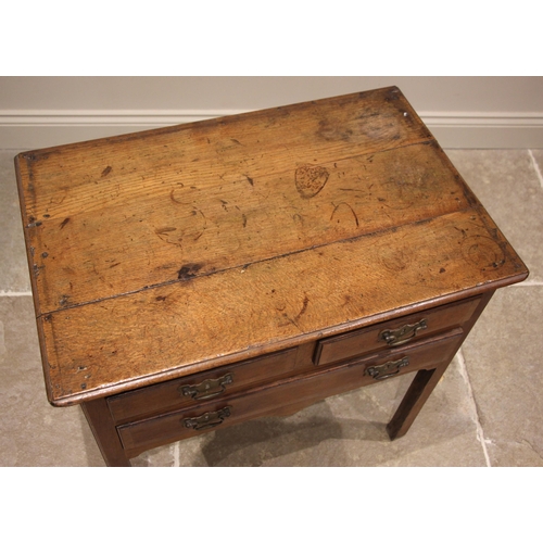 819 - A George III honey oak low boy, the three plank moulded top above an arrangement of two short and on... 