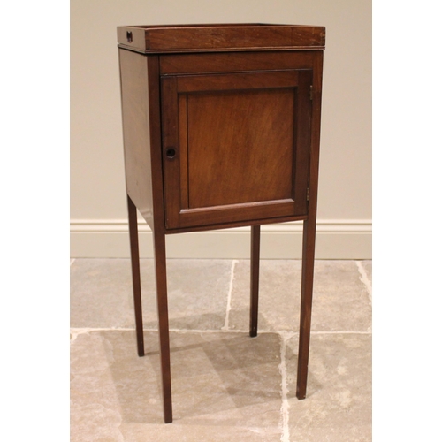 822 - A George III mahogany tray top pot cupboard, the galleried top over a single panelled door, upon sle... 