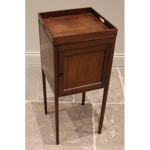 822 - A George III mahogany tray top pot cupboard, the galleried top over a single panelled door, upon sle... 