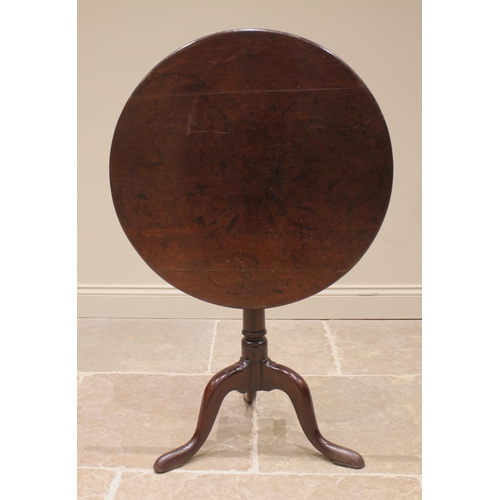 826 - A George III mahogany tripod table, the circular top upon a bird cage mechanism and a ring turned gu... 