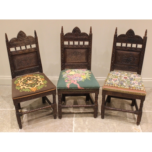 836 - A trio of carved oak hall/side chairs in the 17th century style, late 19th century, each with spire ... 