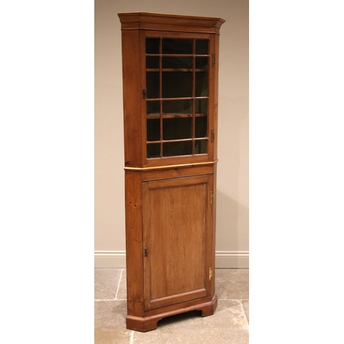 839 - A 19th century and later pine freestanding corner cabinet, the moulded cornice over a single glazed ... 