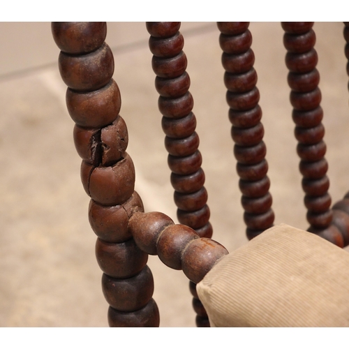 840 - A mahogany bobbin turned armchair, mid to late 19th century, the bobbin frame enclosing a cane work ... 