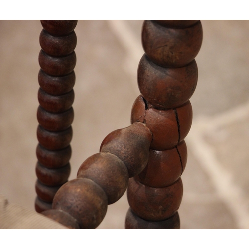 840 - A mahogany bobbin turned armchair, mid to late 19th century, the bobbin frame enclosing a cane work ... 